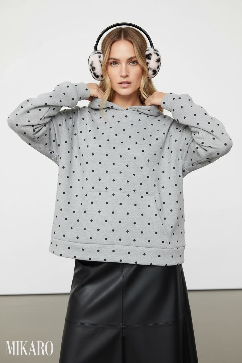 Contemporary Chic: Polka Dot Hoodie & Vegan Leather Skirt in an Art Gallery