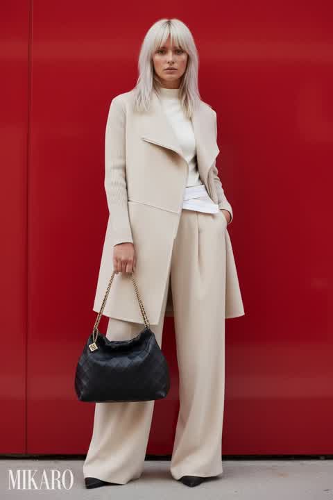 Elegant Neutral Ensemble with Bold Red Backdrop